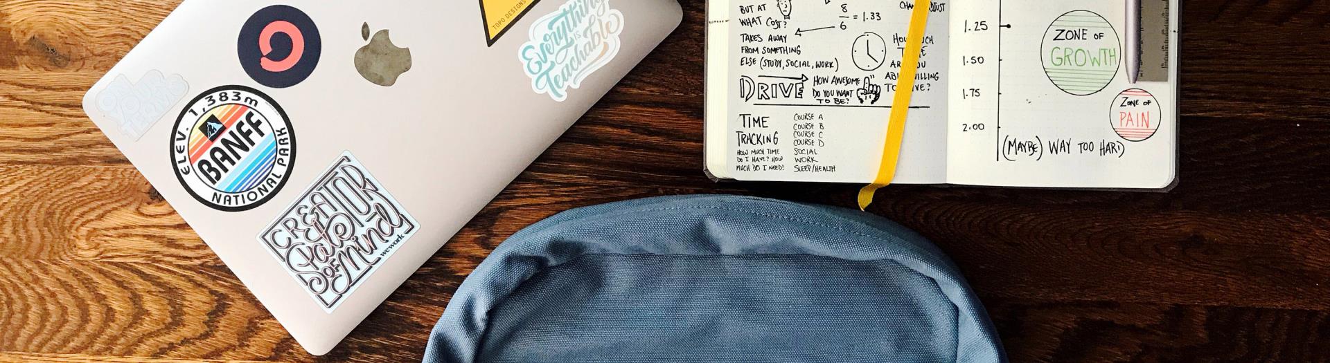 image of a backpack, notebook, and laptop