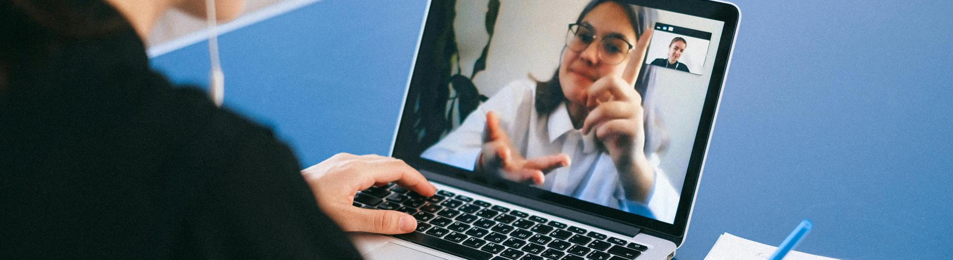 a person speaking to another via online meeting softward