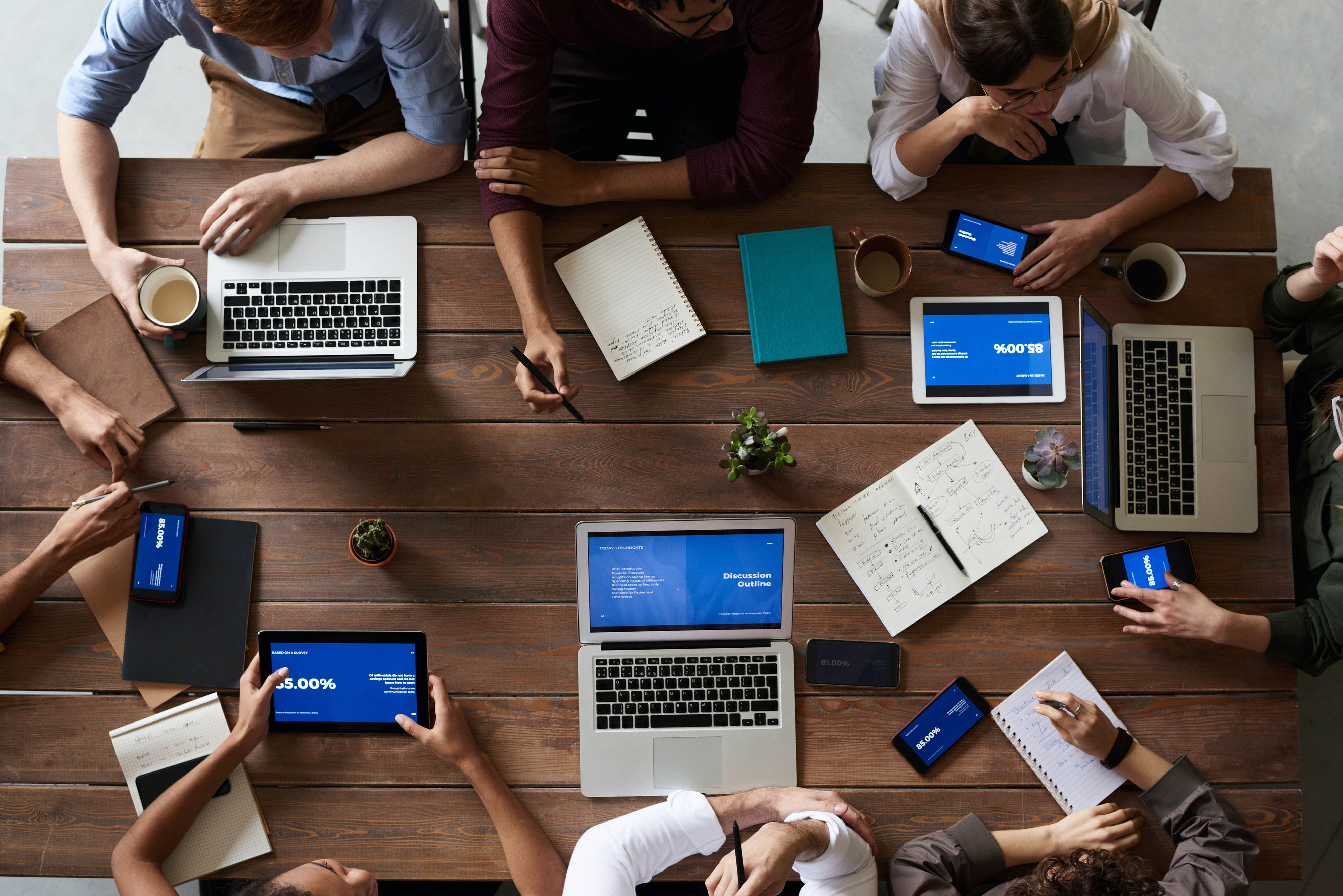 team of people working around a table on a project