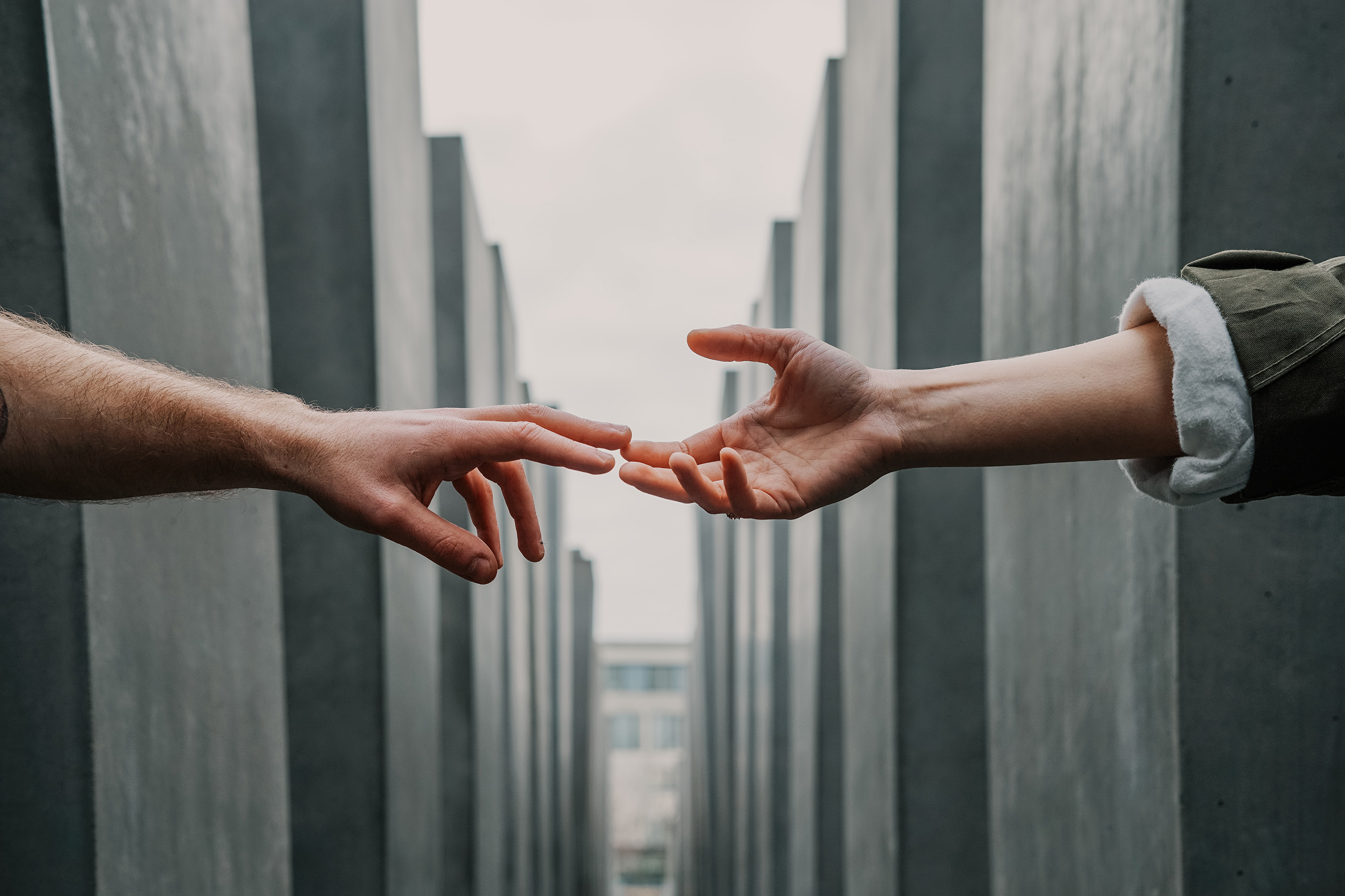 two hands reaching out to one another