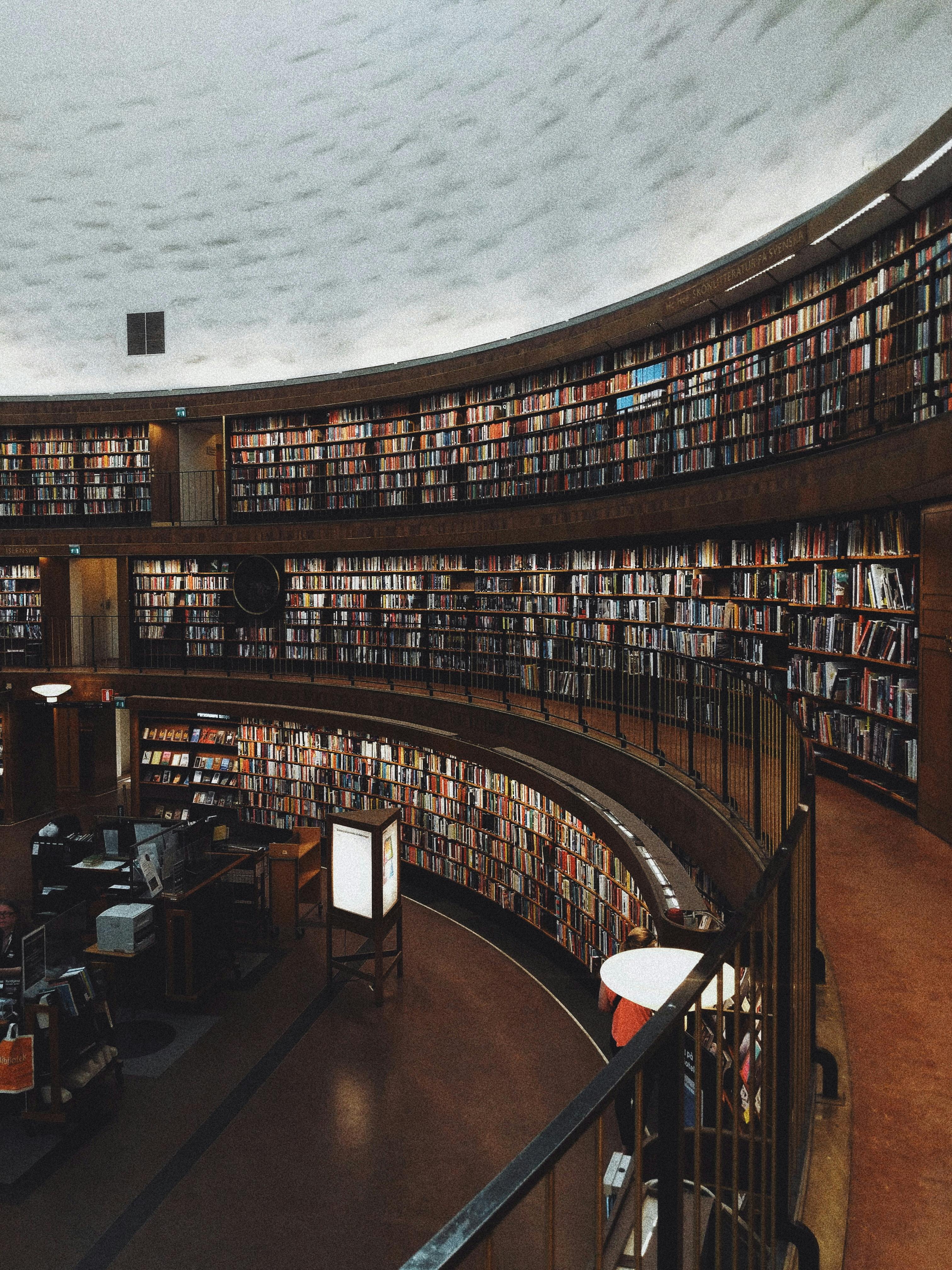 a curved library wall full of books